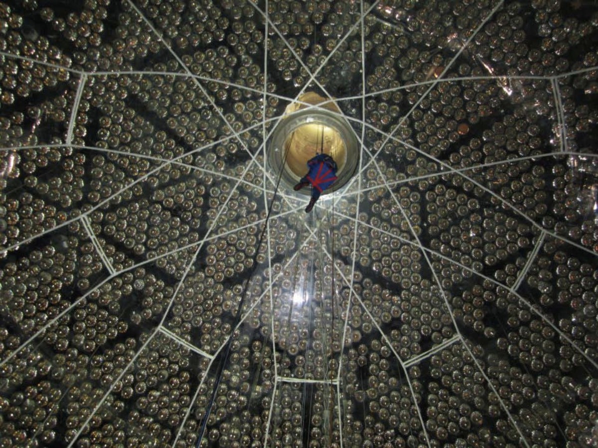 Scientist being lowered into the S­NO+ acrylic vessel to prepare the detector for filling.